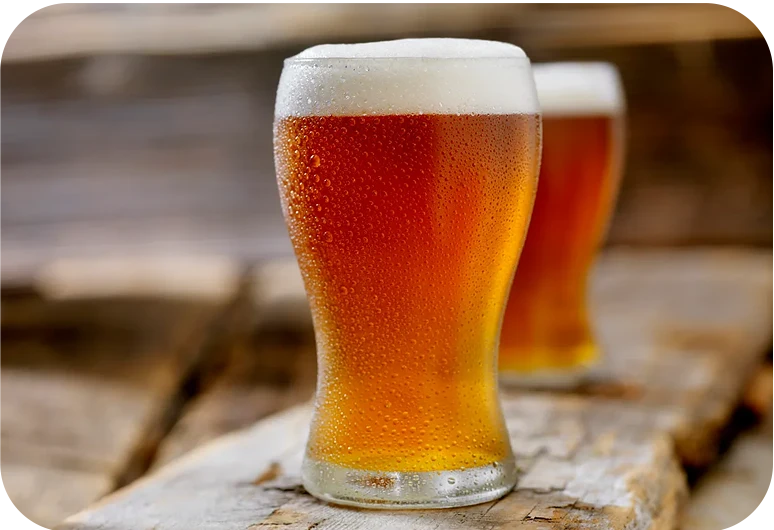 two glasses of drink on top of wooden board